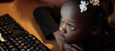 Black child looking at computer
